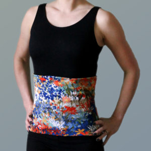 A floral backwarmer over a black bodysuit on a woman's body